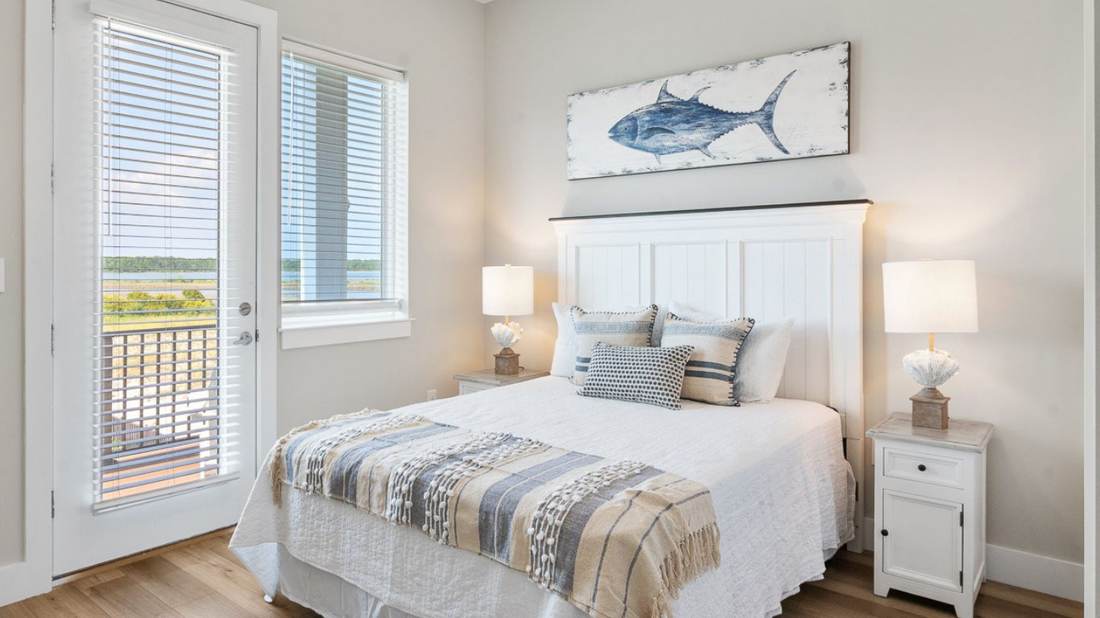 Bright coastal bedroom in a managed rental home