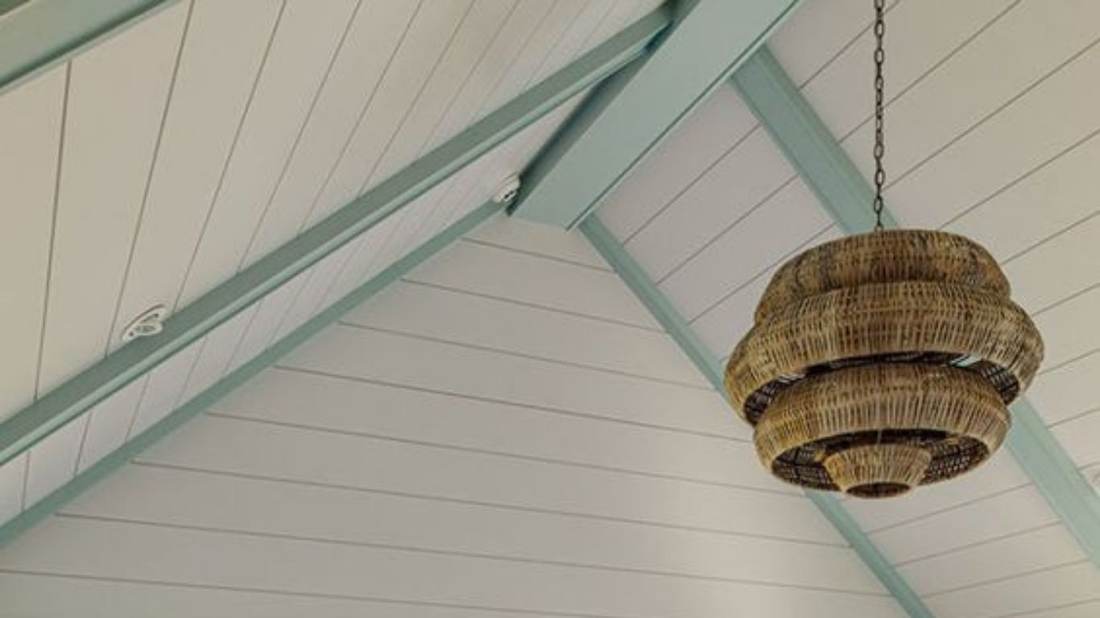 Coastal porch ceiling with a woven pendant light